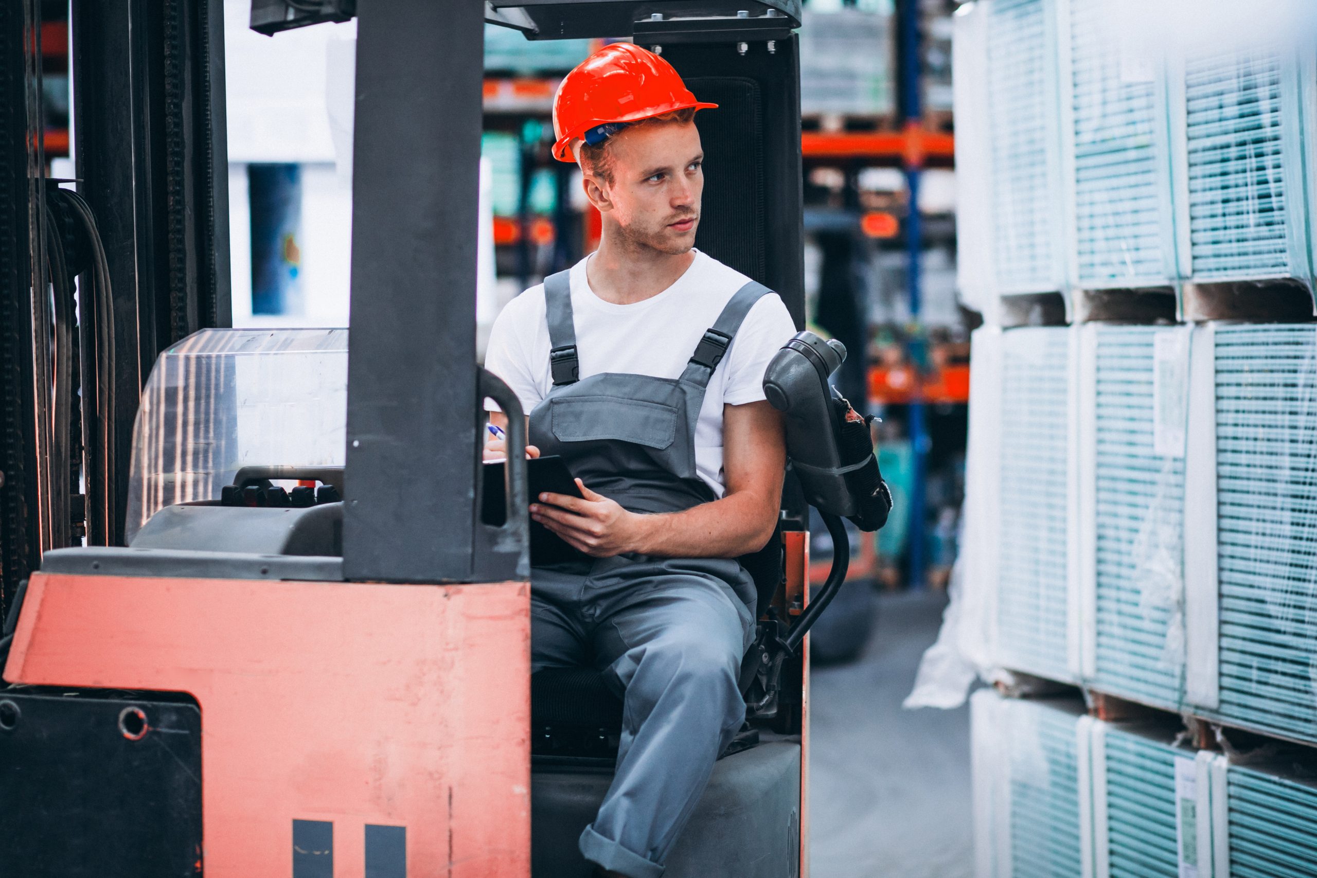 young-man-working-warehouse-with-boxes